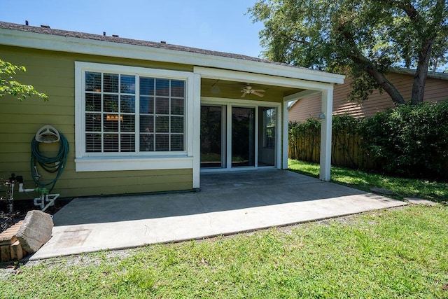 back of house with a ceiling fan and a patio area