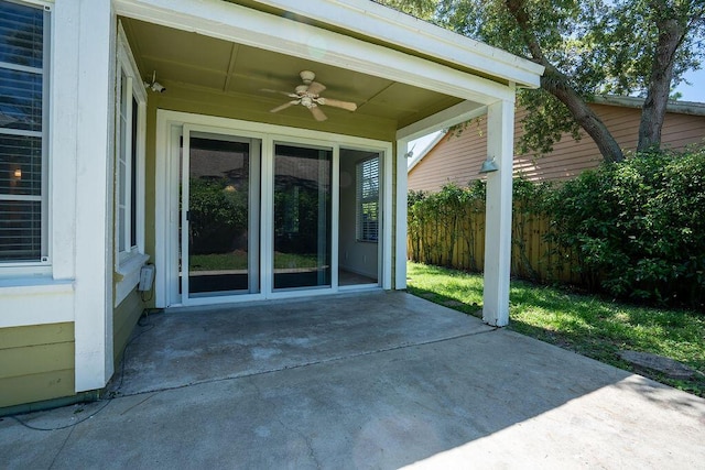 view of patio featuring ceiling fan and fence