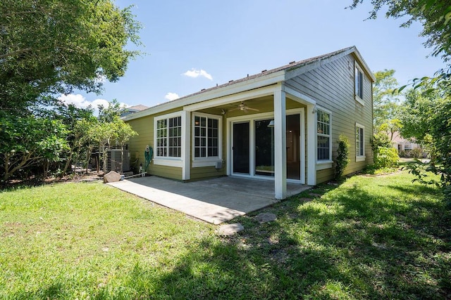 rear view of house with a lawn, a patio, and ceiling fan