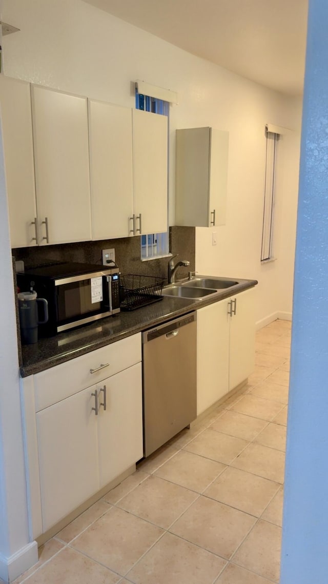 3608 Shoma Dr, Royal Palm Beach, FL 33414 - kitchen with appliances with stainless steel finishes, decorative backsplash, light tile patterned floors, a sink, and dark countertops