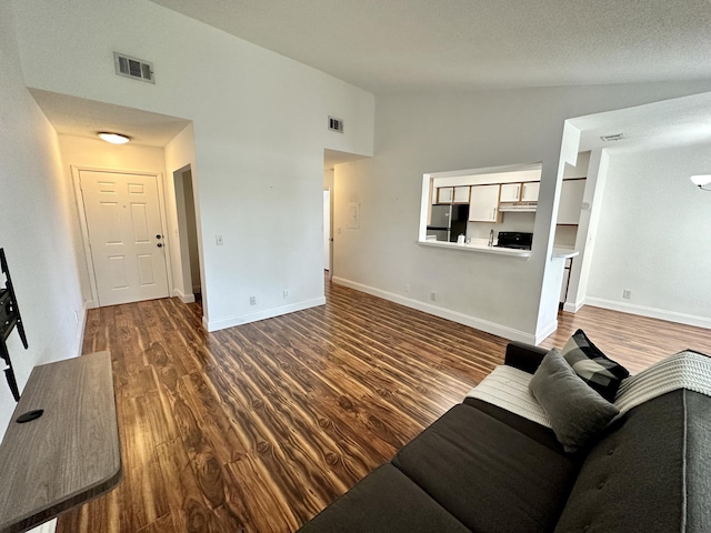 815 W Boynton Beach Blvd Unit 8-204, Boynton Beach, FL 33426 - living area with wood finished floors, baseboards, and high vaulted ceiling