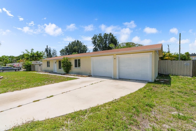 ranch-style house featuring stucco siding, driveway, and a garage