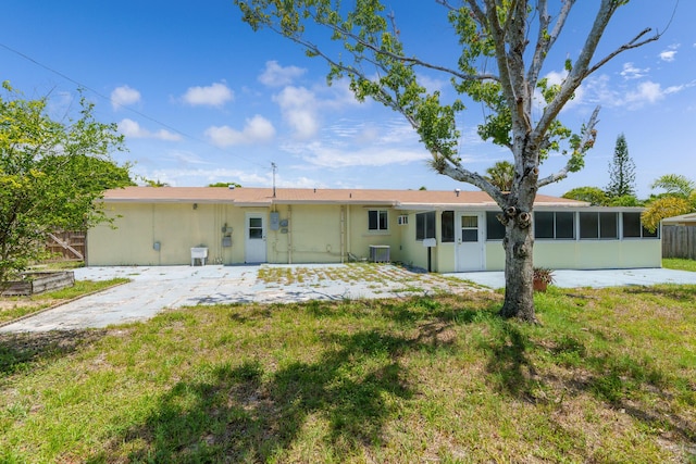 back of house with a sunroom and central AC