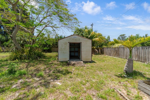 view of yard featuring a storage shed and an outdoor structure