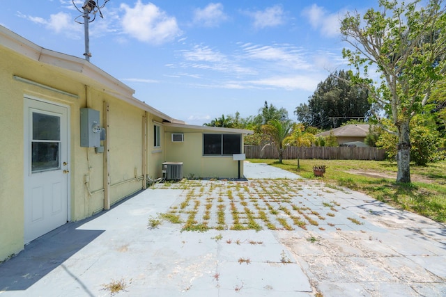 view of patio with fence and cooling unit