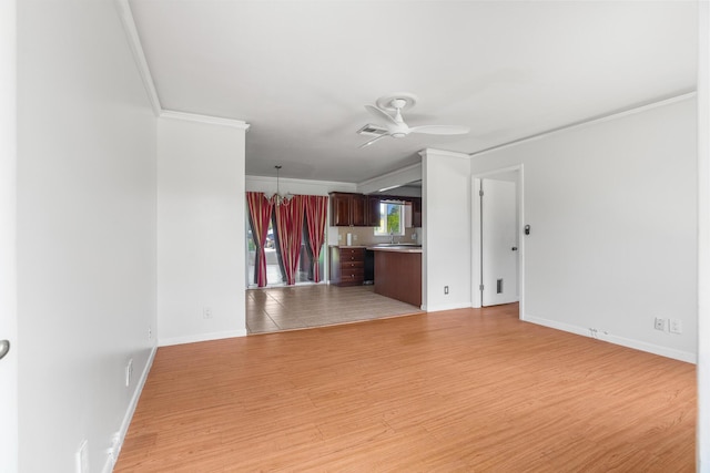 unfurnished living room featuring crown molding, light wood-style floors, ceiling fan, and baseboards