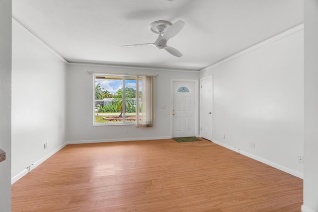 spare room featuring ceiling fan, crown molding, light wood-style flooring, and baseboards