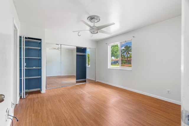 unfurnished bedroom with light wood-style floors, ceiling fan, and baseboards