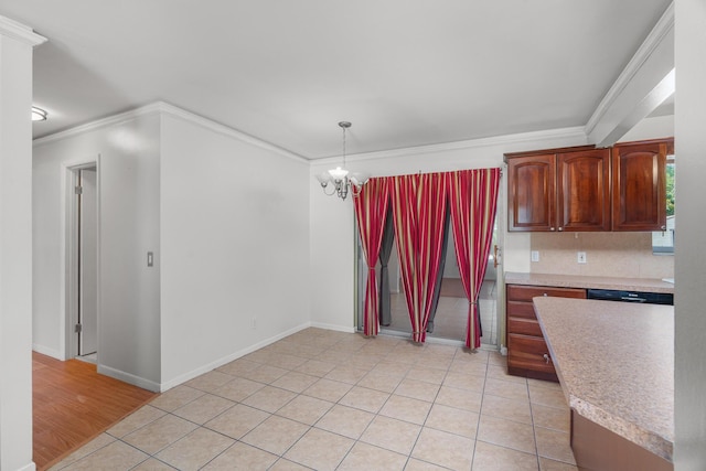 kitchen with light countertops, ornamental molding, a chandelier, pendant lighting, and baseboards