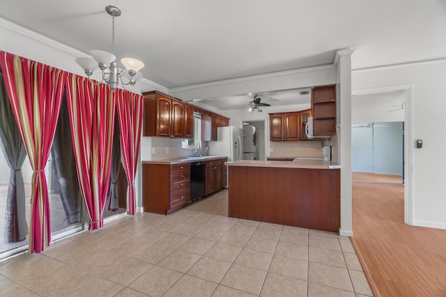 kitchen featuring black dishwasher, light countertops, crown molding, a ceiling fan, and a chandelier