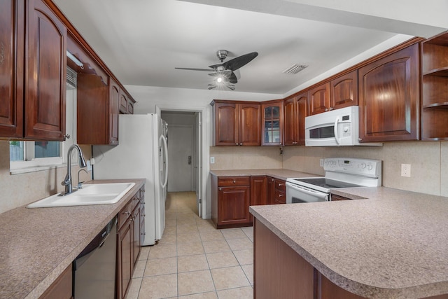 kitchen with white appliances, a sink, decorative backsplash, and open shelves