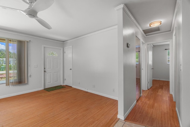 foyer featuring light wood-style flooring, ornamental molding, baseboards, and a ceiling fan