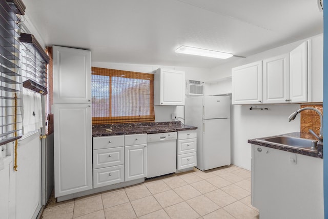 kitchen with white appliances, a sink, white cabinets, and light tile patterned flooring