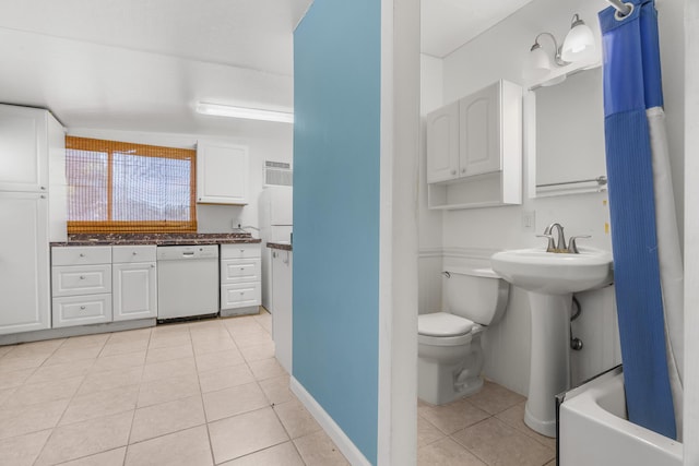 bathroom featuring tile patterned flooring and toilet