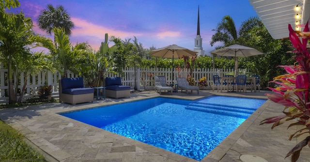 1001 N Lakeside Dr, Lake Worth Beach, FL 33460 - pool at dusk featuring a patio area