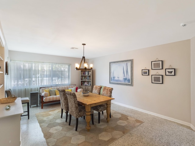 1001 N Lakeside Dr, Lake Worth Beach, FL 33460 - dining room featuring a chandelier, baseboards, and dark aggregate flooring