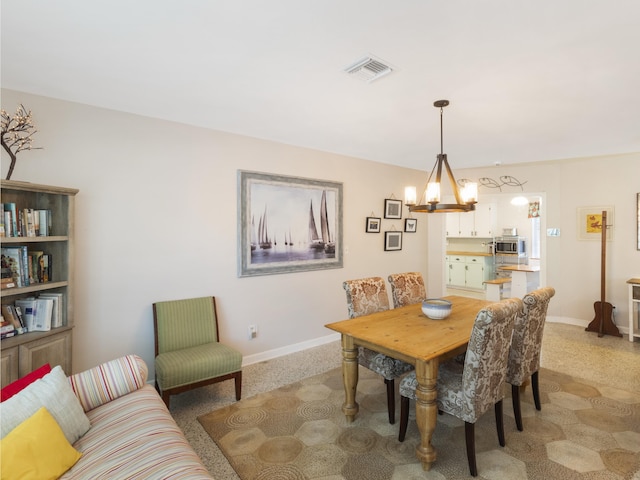 1001 N Lakeside Dr, Lake Worth Beach, FL 33460 - dining room featuring a chandelier and baseboards