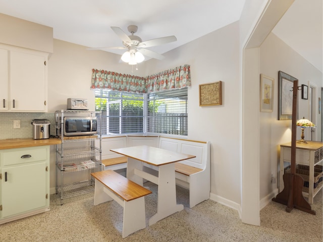 1001 N Lakeside Dr, Lake Worth Beach, FL 33460 - dining space featuring a ceiling fan, baseboards, and dark speckled floor