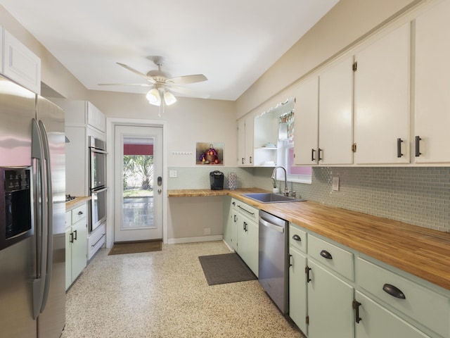 1001 N Lakeside Dr, Lake Worth Beach, FL 33460 - kitchen with stainless steel appliances, a sink, plenty of natural light, and tasteful backsplash