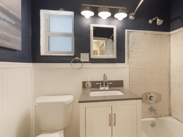 1001 N Lakeside Dr, Lake Worth Beach, FL 33460 - full bathroom with toilet, shower / tub combination, vanity, and a wainscoted wall