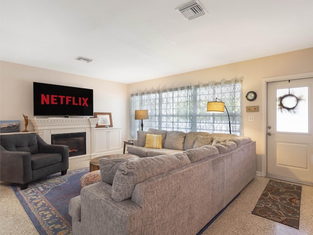1001 N Lakeside Dr, Lake Worth Beach, FL 33460 - carpeted living room with healthy amount of natural light and a glass covered fireplace