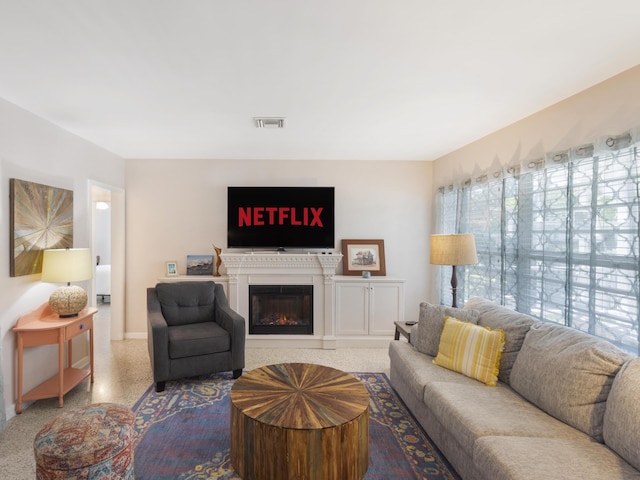 1001 N Lakeside Dr, Lake Worth Beach, FL 33460 - living area with speckle patterned floor, baseboards, and a glass covered fireplace