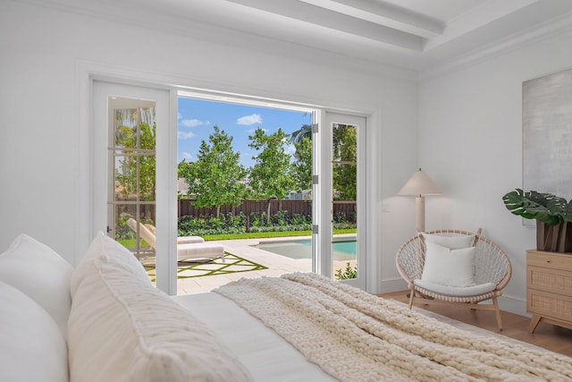 bedroom with wood finished floors and access to outside