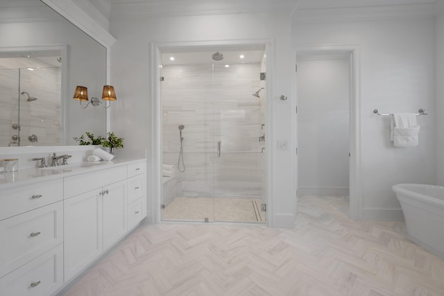 full bathroom featuring a shower stall, vanity, a freestanding bath, crown molding, and baseboards
