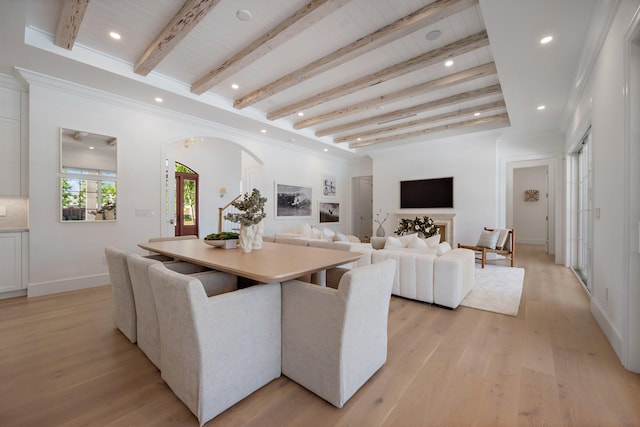 dining area with arched walkways, light wood finished floors, wood ceiling with exposed beams, recessed lighting, and baseboards
