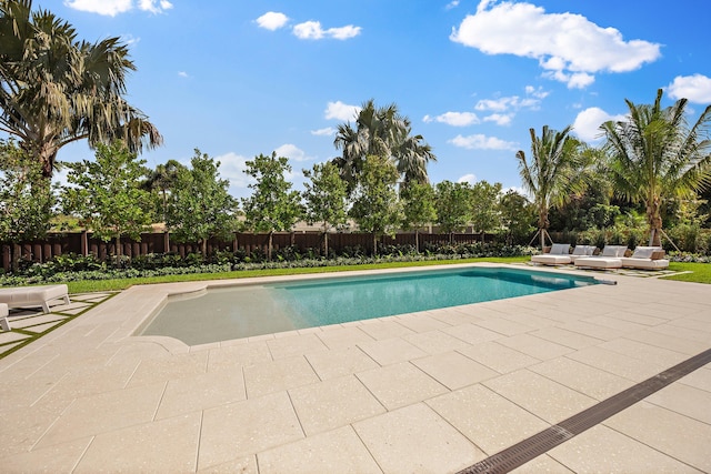 view of pool with a patio, an outdoor living space, and a fenced backyard