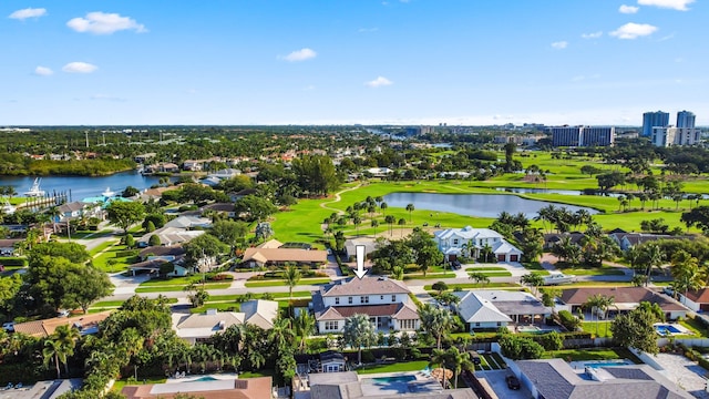 aerial perspective of suburban area with a nearby body of water and a local golf course