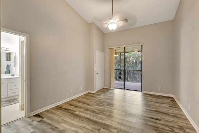 5450 Verona Dr Unit L, Boynton Beach, FL 33437 - unfurnished room featuring light wood-type flooring, baseboards, vaulted ceiling, and a chandelier