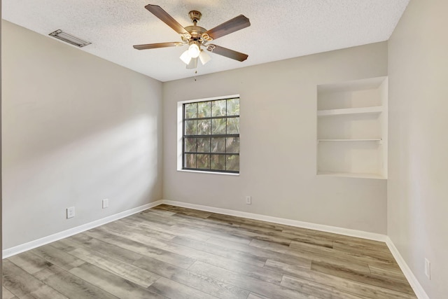 5450 Verona Dr Unit L, Boynton Beach, FL 33437 - empty room featuring a textured ceiling, ceiling fan, wood finished floors, and baseboards