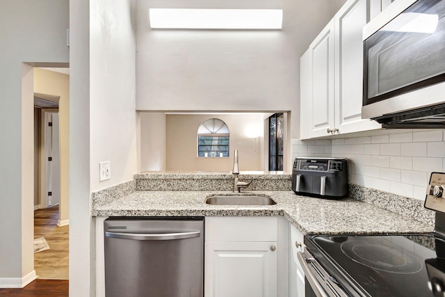 5450 Verona Dr Unit L, Boynton Beach, FL 33437 - kitchen featuring appliances with stainless steel finishes, a sink, decorative backsplash, white cabinets, and dark wood-style flooring