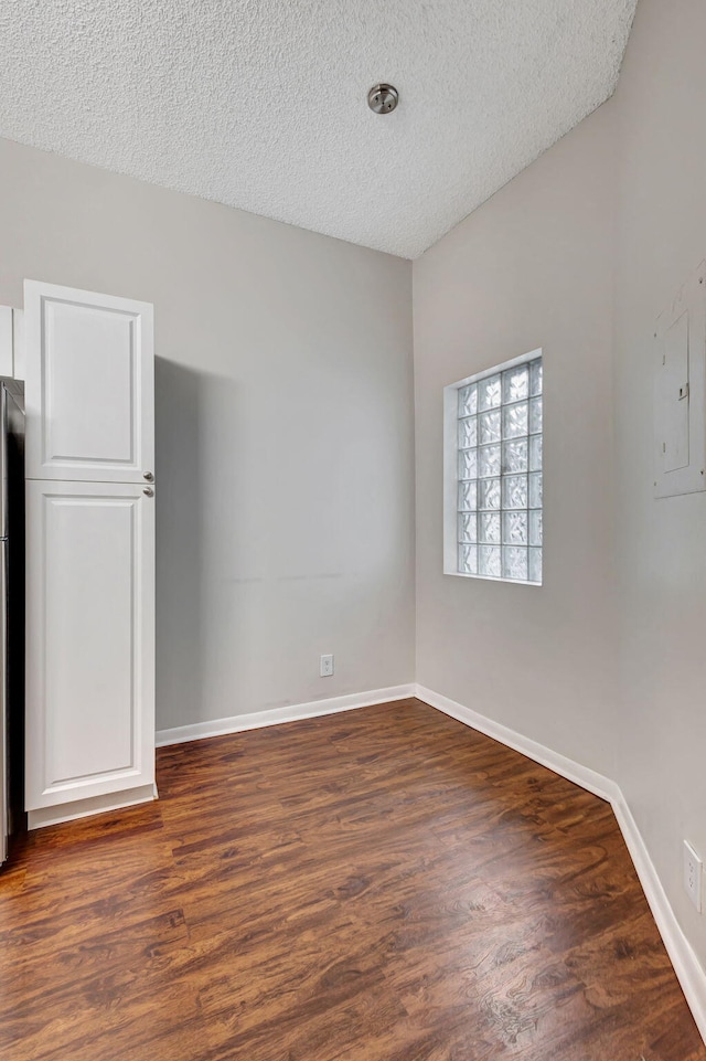 5450 Verona Dr Unit L, Boynton Beach, FL 33437 - unfurnished room featuring a textured ceiling, dark wood finished floors, and baseboards