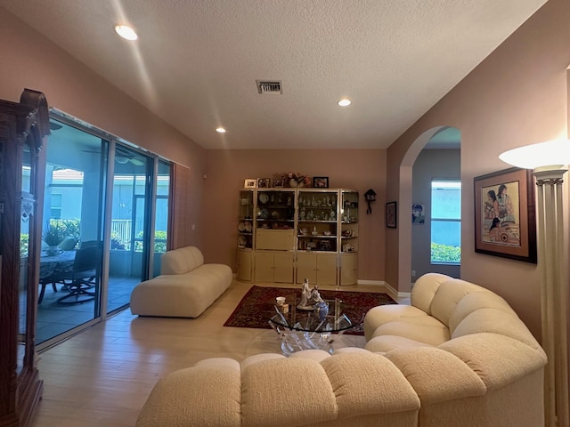 473 Cottagewood Ln, West Palm Beach, FL 33411 - living area featuring arched walkways, recessed lighting, a textured ceiling, and wood finished floors