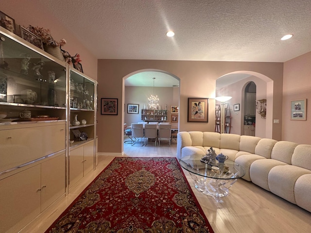 473 Cottagewood Ln, West Palm Beach, FL 33411 - living area with arched walkways, a textured ceiling, a chandelier, baseboards, and recessed lighting