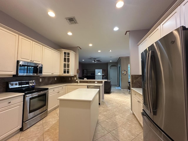 473 Cottagewood Ln, West Palm Beach, FL 33411 - kitchen featuring stainless steel appliances, a peninsula, recessed lighting, decorative backsplash, and a kitchen island
