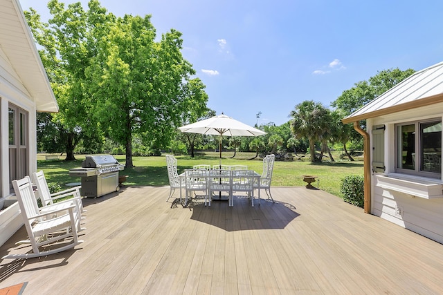 32801 US Highway 441 N Unit 64, Okeechobee, FL 34972 - wooden terrace with outdoor dining space, a yard, and a grill