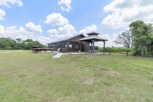 32801 US Highway 441 N Unit 64, Okeechobee, FL 34972 - back of property featuring a gazebo, a yard, and a sunroom