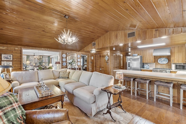 32801 US Highway 441 N Unit 64, Okeechobee, FL 34972 - living room with a chandelier, wooden ceiling, lofted ceiling, light wood-style floors, and wooden walls