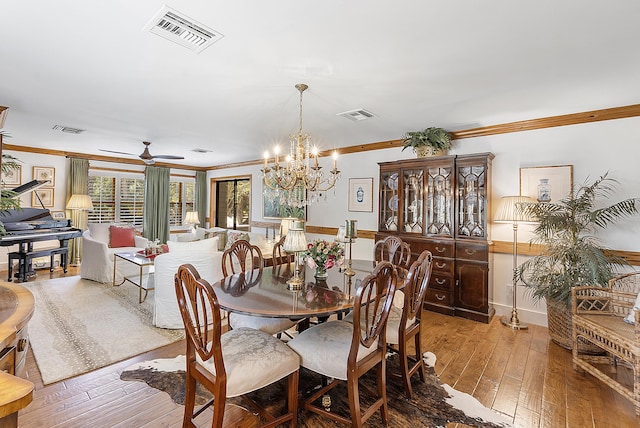 32801 US Highway 441 N Unit 64, Okeechobee, FL 34972 - dining space with ornamental molding, wood-type flooring, ceiling fan, and a chandelier