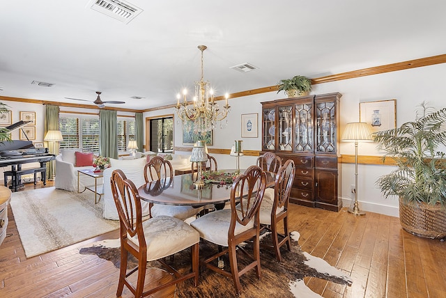 32801 US Highway 441 N Unit 64, Okeechobee, FL 34972 - dining space featuring crown molding, light wood-style flooring, a chandelier, baseboards, and a ceiling fan