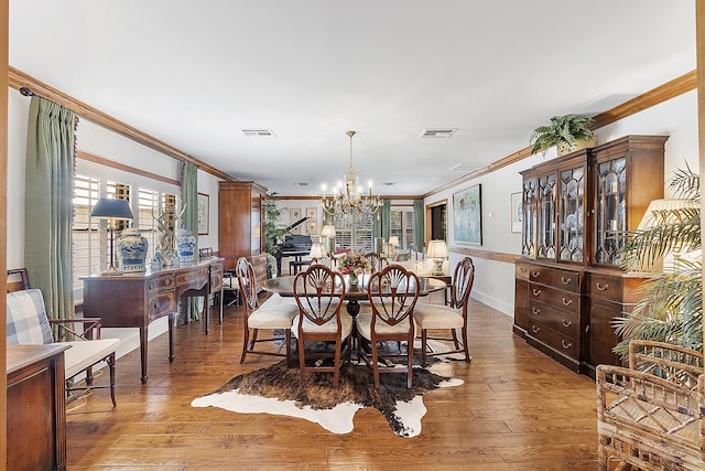 32801 US Highway 441 N Unit 64, Okeechobee, FL 34972 - dining area with ornamental molding, a chandelier, plenty of natural light, hardwood / wood-style flooring, and baseboards