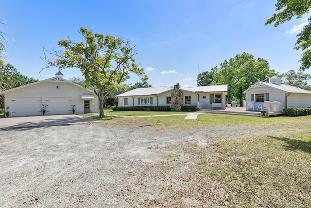 32801 US Highway 441 N Unit 64, Okeechobee, FL 34972 - view of front of property with a chimney, a garage, a front yard, and a deck