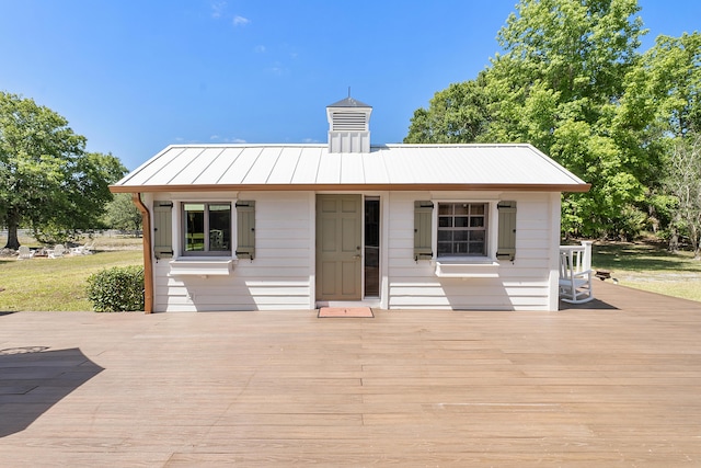 32801 US Highway 441 N Unit 64, Okeechobee, FL 34972 - rear view of house with a wooden deck, a standing seam roof, and metal roof