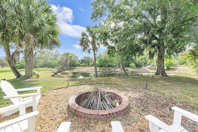32801 US Highway 441 N Unit 64, Okeechobee, FL 34972 - view of grassy yard with an outdoor fire pit and a water view
