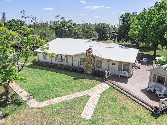 32801 US Highway 441 N Unit 64, Okeechobee, FL 34972 - view of front of home with a wooden deck, metal roof, a front lawn, and view of wooded area