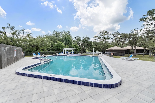 32801 US Highway 441 N Unit 64, Okeechobee, FL 34972 - community pool featuring fence, a patio area, and view of scattered trees