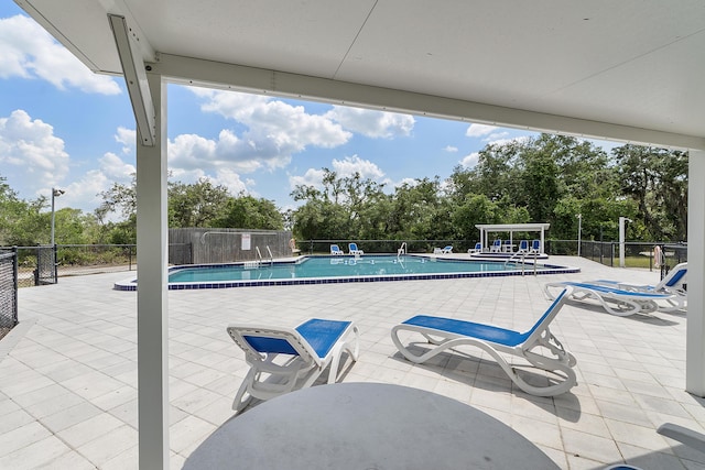 32801 US Highway 441 N Unit 64, Okeechobee, FL 34972 - community pool featuring fence, view of wooded area, and a patio area
